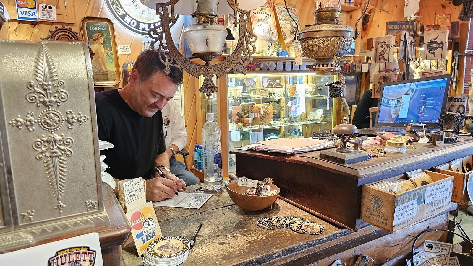 Bob Coronato fills out a sales ticket at his shop, Rogue's Gallery, in Hulett.