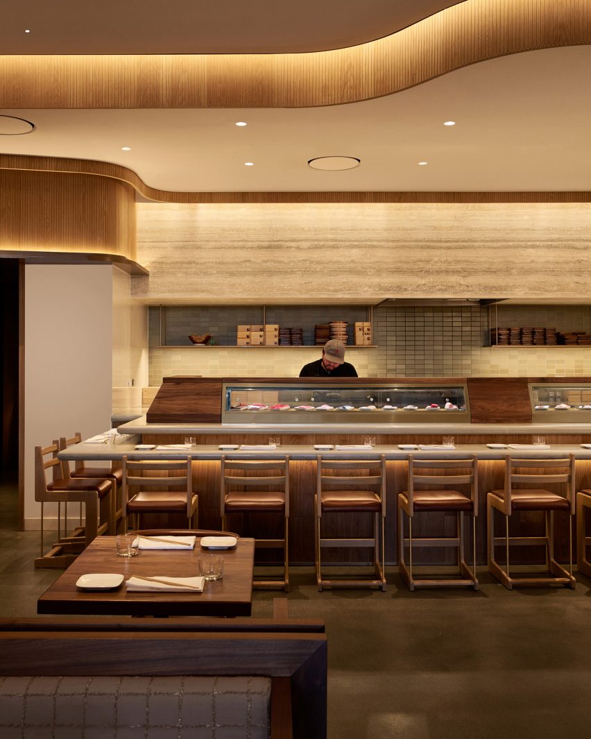 Sushi bar with travertine backsplash