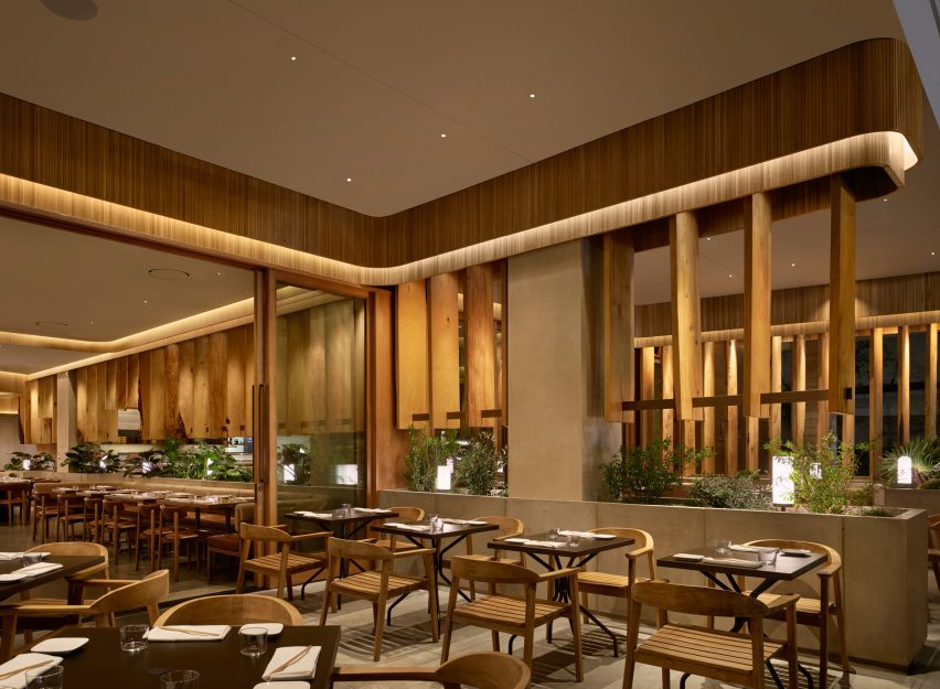 Concrete slabs under wooden baseboards extend to the patio dining area