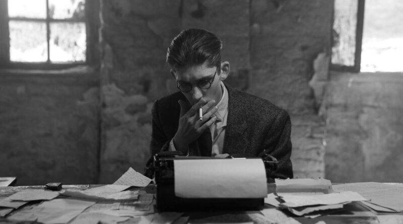 A young man smokes on a typewriter.